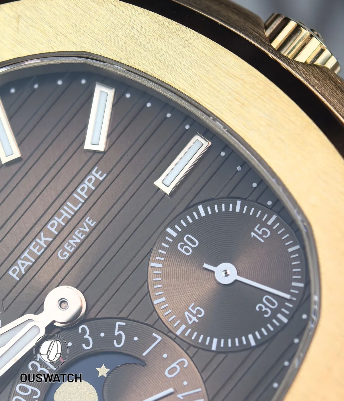 Extreme close-up of the brown dial showing horizontal texture, subdial relief and the moonphase disc artistry.