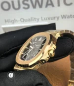 Macro of the signed crown and adjoining case surfaces, showing knurling, crown tube and polished bevels.