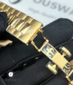 Folding clasp fully opened to reveal stamped hallmarks, adjustment slots and the clasp’s construction detail.