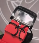 Matte black pin buckle for the RM 35-02 with engraved logo and pin geometry, shown in sharp macro.