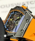 Tight shot of the carbon-fiber case showing its woven texture, lamination layers and precision edge finishing.