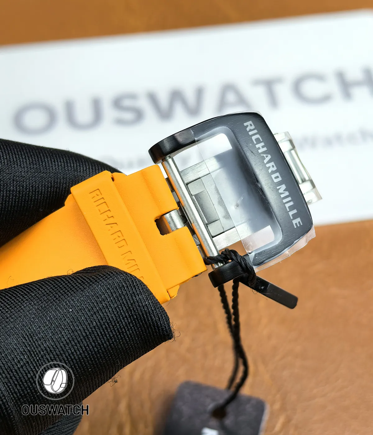 Macro of the stainless pin buckle on the RM 65-01 strap, highlighting pin geometry and stamped branding.