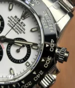 Close-up of Rolex 116500LN white dial and black ceramic bezel detail.