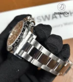 Close detail of Rolex 126500LN 904L stainless steel case and bracelet junction.