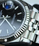 Tight bezel detail capturing the polished rim and subtle light reflections along the edge.