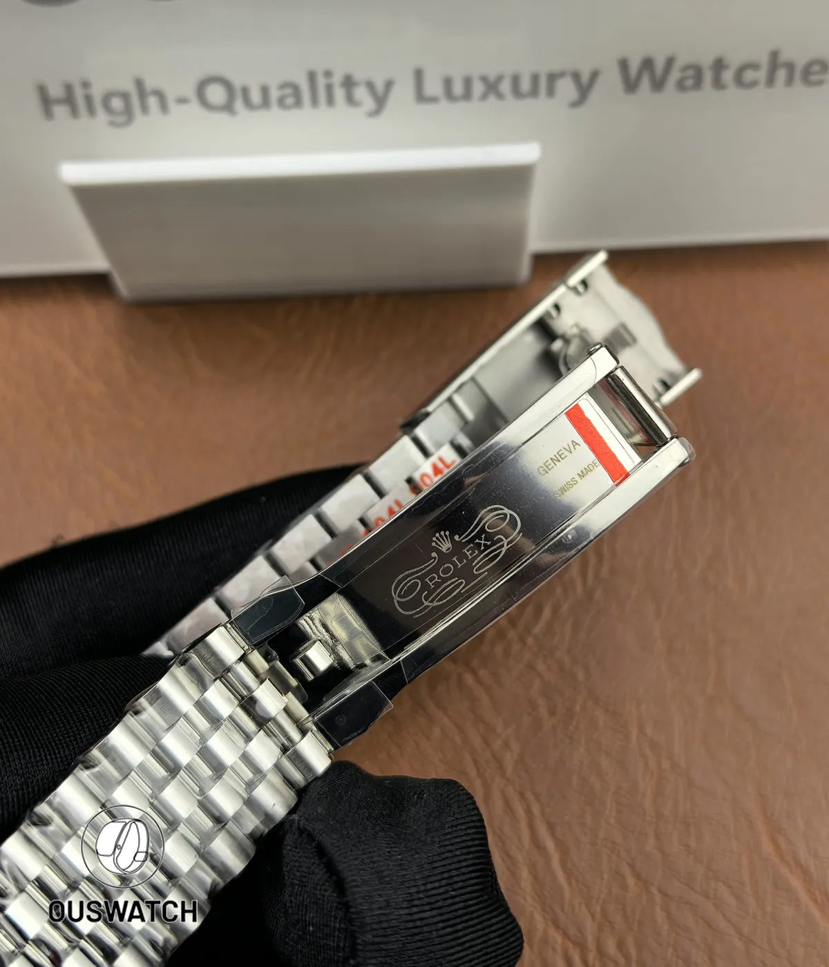 Folding clasp fully opened to reveal the inner locking mechanism and stamped details.