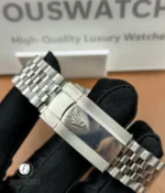 Stainless-steel folding clasp shown closed, displaying brushed surfaces and subtle branding.