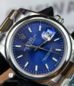 Close-up of the blue sunburst dial with luminous markers and crisp white text on the Datejust 126200.