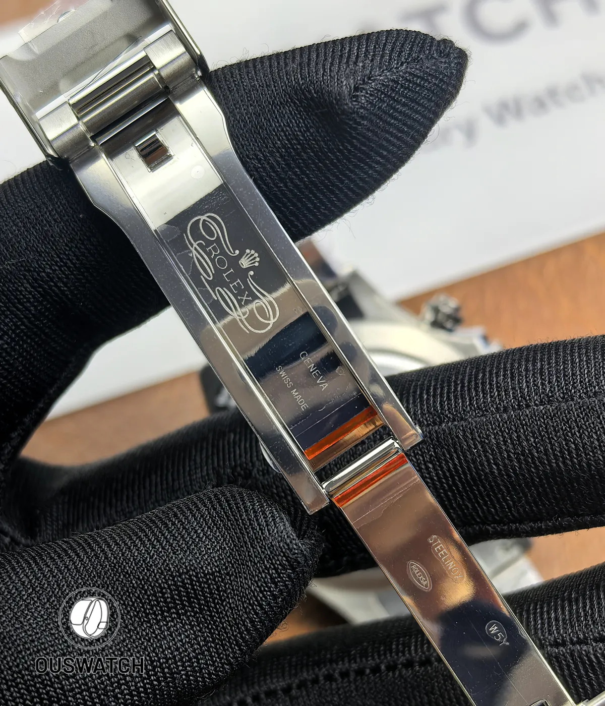 Rolled-out view of Rolex Daytona stainless steel folding clasp fully opened.