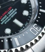 Tight shot of the black ceramic bezel insert with its engraved diving scale and crisp numeral relief.