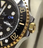 Close detail of the black ceramic bezel with yellow-gold insert on the Deepsea 126603 two-tone model.