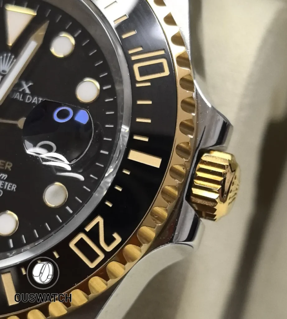 Close detail of the black ceramic bezel with yellow-gold insert on the Deepsea 126603 two-tone model.