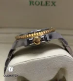 Macro close-up of the 126603 crown, showing engraving, threads and gold crown tube detail.