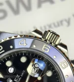 Bezel and crown close-up of Rolex GMT-Master II 126710BLNR showing knurling and crown logo.