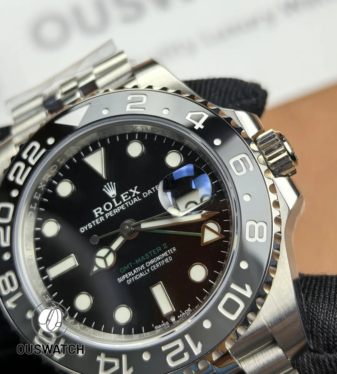 Close-up of the black dial on Rolex GMT-Master II 126710GRNR-0003 showing hour markers and hands.