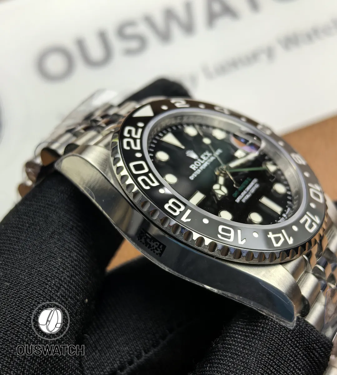 Side profile of the Rolex GMT-Master II 126710GRNR-0003 case showing crown guards and finish.