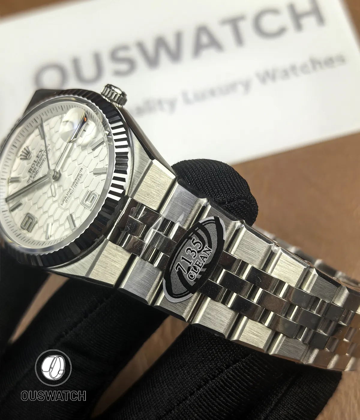 130° angled overview of Rolex Land-Dweller 40 127334-0001 displaying dial, bezel and bracelet.