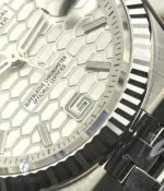 Macro close-up of the white honeycomb dial on Rolex Land-Dweller 127334-0001, showing texture and markers.