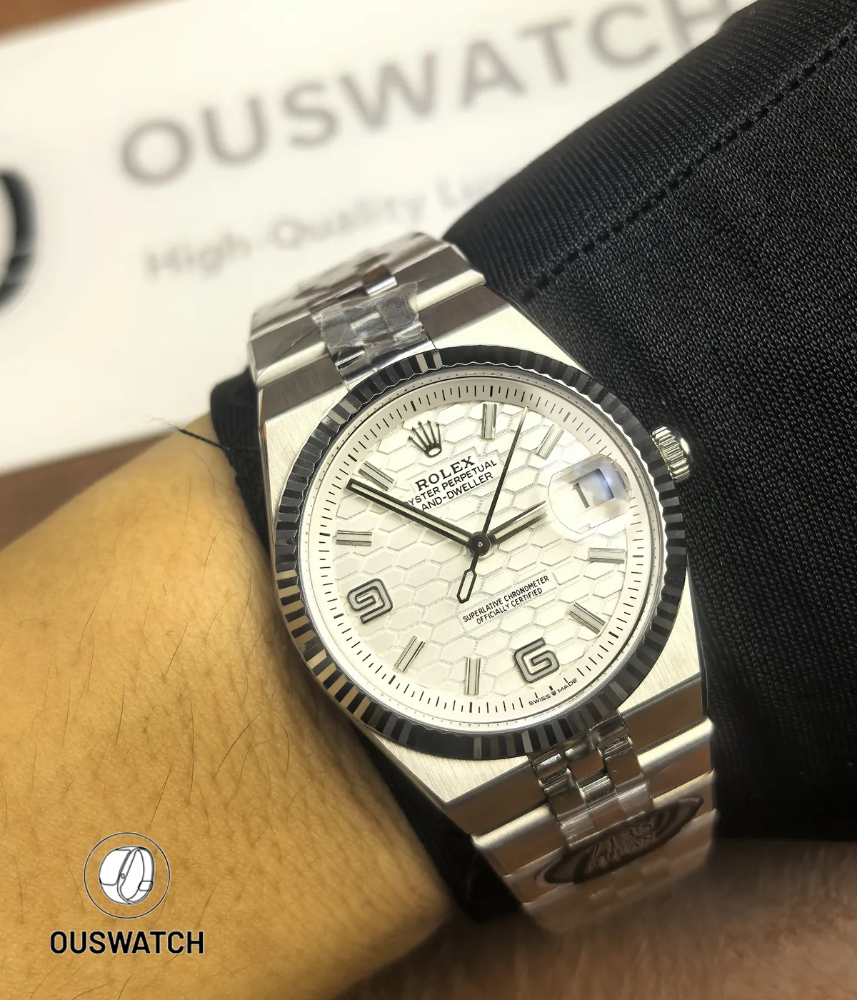 Wrist shot of Rolex Land-Dweller 40 127334-0001 with white honeycomb dial, showing wear and fit.