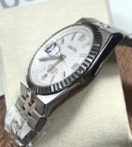 Side profile showing grooved bezel and satin-brushed finish on Rolex Land-Dweller 127234.