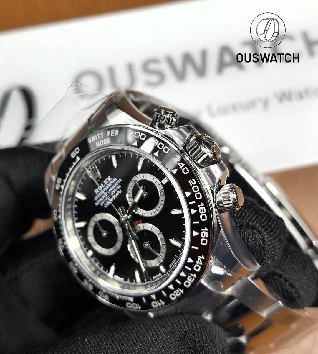 Close-up of Rolex Panda 126500LN black dial, ceramic bezel and chronograph pushers.