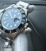 Tilted dial view of the 116610LN that highlights handset shadowing and radial dial texture under light.