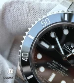 Detail view of the black ceramic bezel and adjacent dial, focusing on the crisp minute scale and date window.