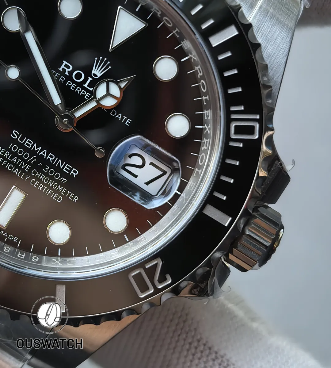 Close-up showing the date magnifier, date wheel font and bezel graduation on the Submariner 116610LN