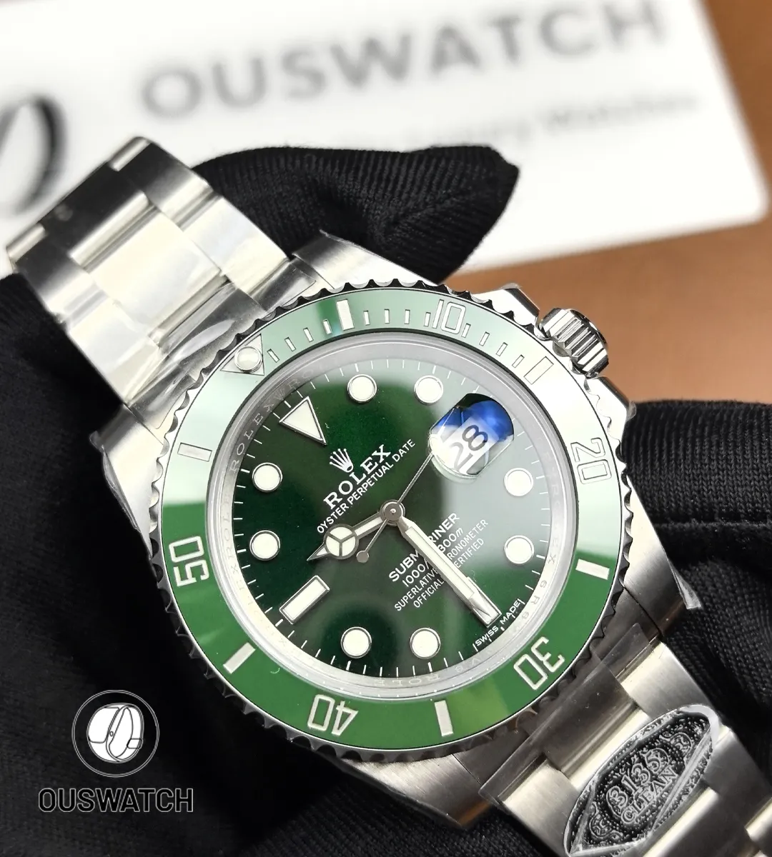 Extreme close-up of the green dial showing applied hour markers, hands and fine sunburst texture.