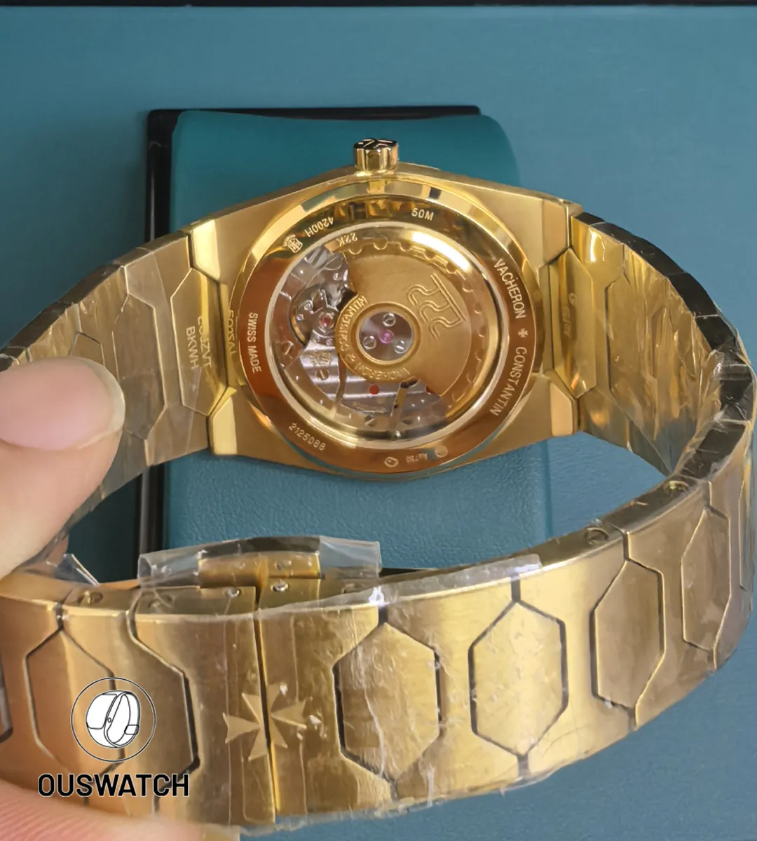 Rear composition showing the bracelet junction and exhibition view of the movement beneath the caseback.