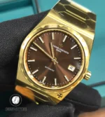 Macro detail of the brown dial: textured finish, applied indices and the subtle sheen of the hands.