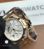 Close detail of the signed crown and crown tube, highlighting knurling and polished bevels on the case.