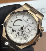 Macro of the white dial showing the dual-time indicator, textured surface and finely printed minute track.