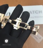 Unfolded folding clasp in rose gold showing locking elements, stamped marks and micro-adjust slots.