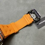 Macro of the RM 11-03 McLaren pin buckle with branded engraving and matte-brushed finish.