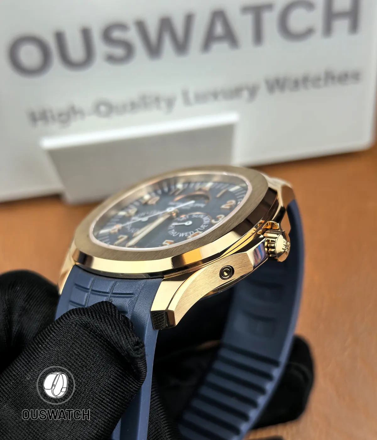 Side shot showing the crown side of the Aquanaut 5261R-001 with satin-finished rose gold case and integrated blue rubber strap connection.
