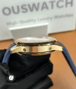 Macro close-up of the Aquanaut 5261R-001 lugs in 18k rose gold, showing the curved integration between the case and blue rubber strap.