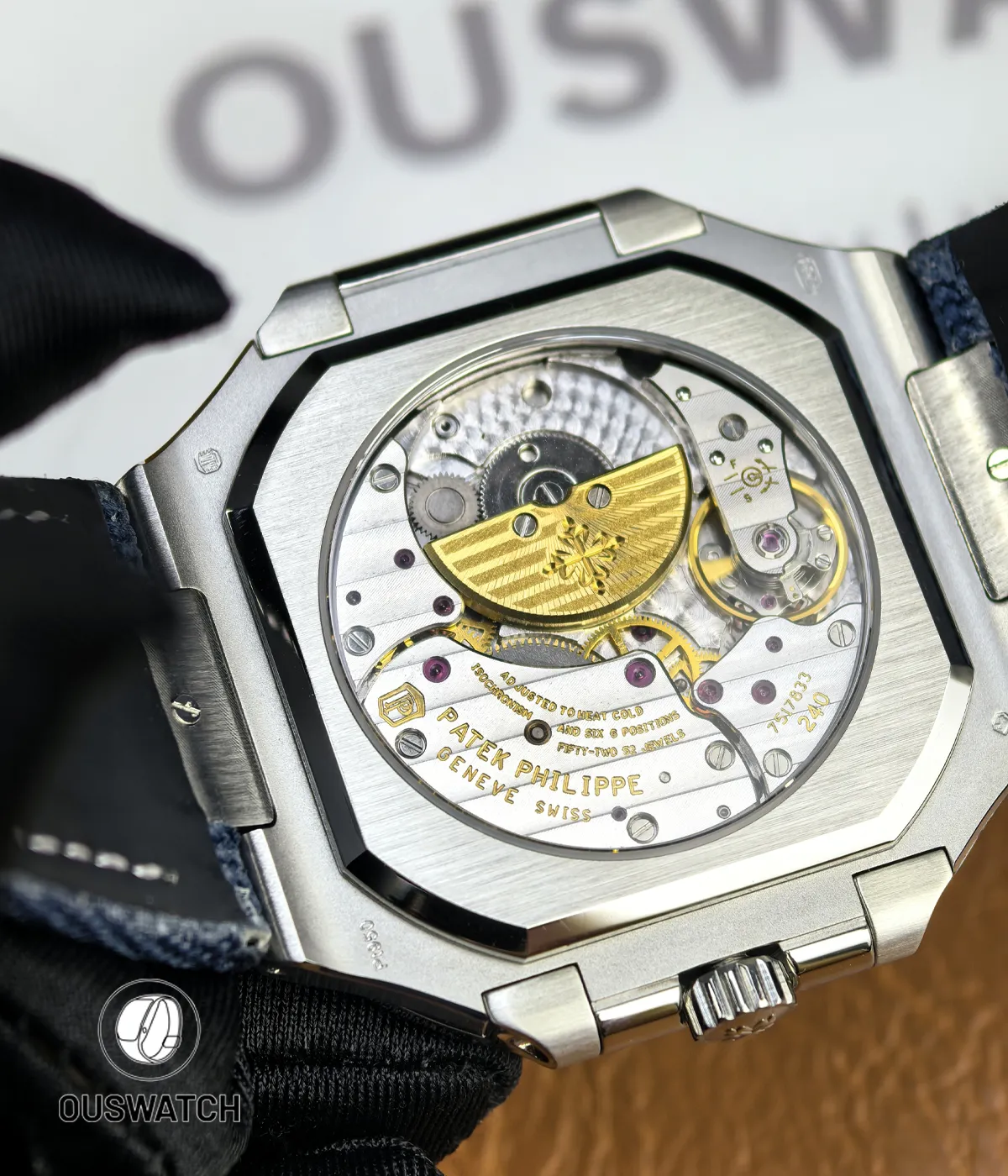 Macro image of the movement components visible through the caseback, showcasing decoration and engraving.