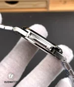 Side profile showcasing the Nautilus case geometry and polished bezel edge against the blue dial backdrop.