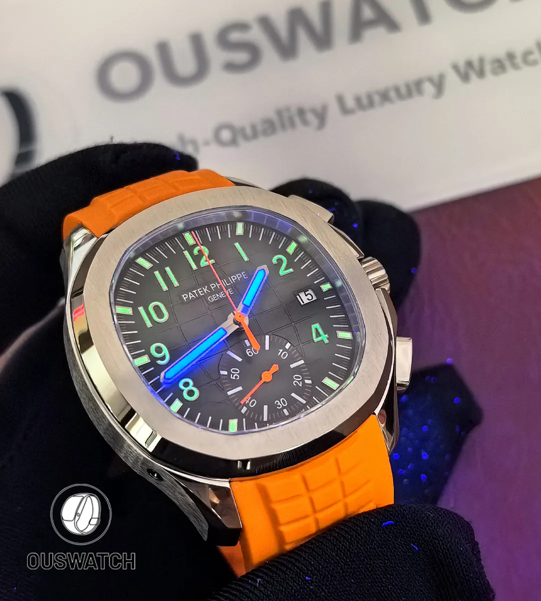 Upward 45-degree view of the Patek Philippe Aquanaut Chronograph 5968A-001 under black light, revealing the luminous dial markers and bold sports chronograph design.