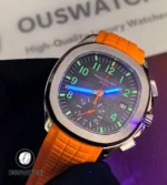Patek Philippe Aquanaut Chronograph 5968A-001 at a 45-degree right angle under UV light, showcasing the vivid Super-LumiNova glow of its numerals and hands in low light.