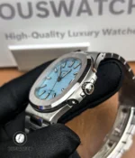 Detailed shot of the crown on the Patek Philippe Nautilus 5711/1A-018 Tiffany & Co, engraved with the Calatrava cross and finely knurled for precise adjustment.