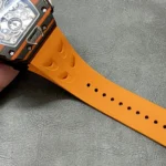 Textured yellow rubber strap for the RM 11-03 McLaren chronograph, showing strap pattern, stitching and endlink fit.