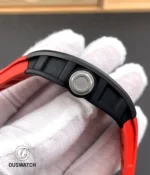 Side profile of the RM 055 Bubba Watson red edition highlighting the titanium crown and curved ceramic case.