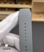 Textured rubber strap for the RM 055 laid flat to show grain, endlink fit and buckle connection.