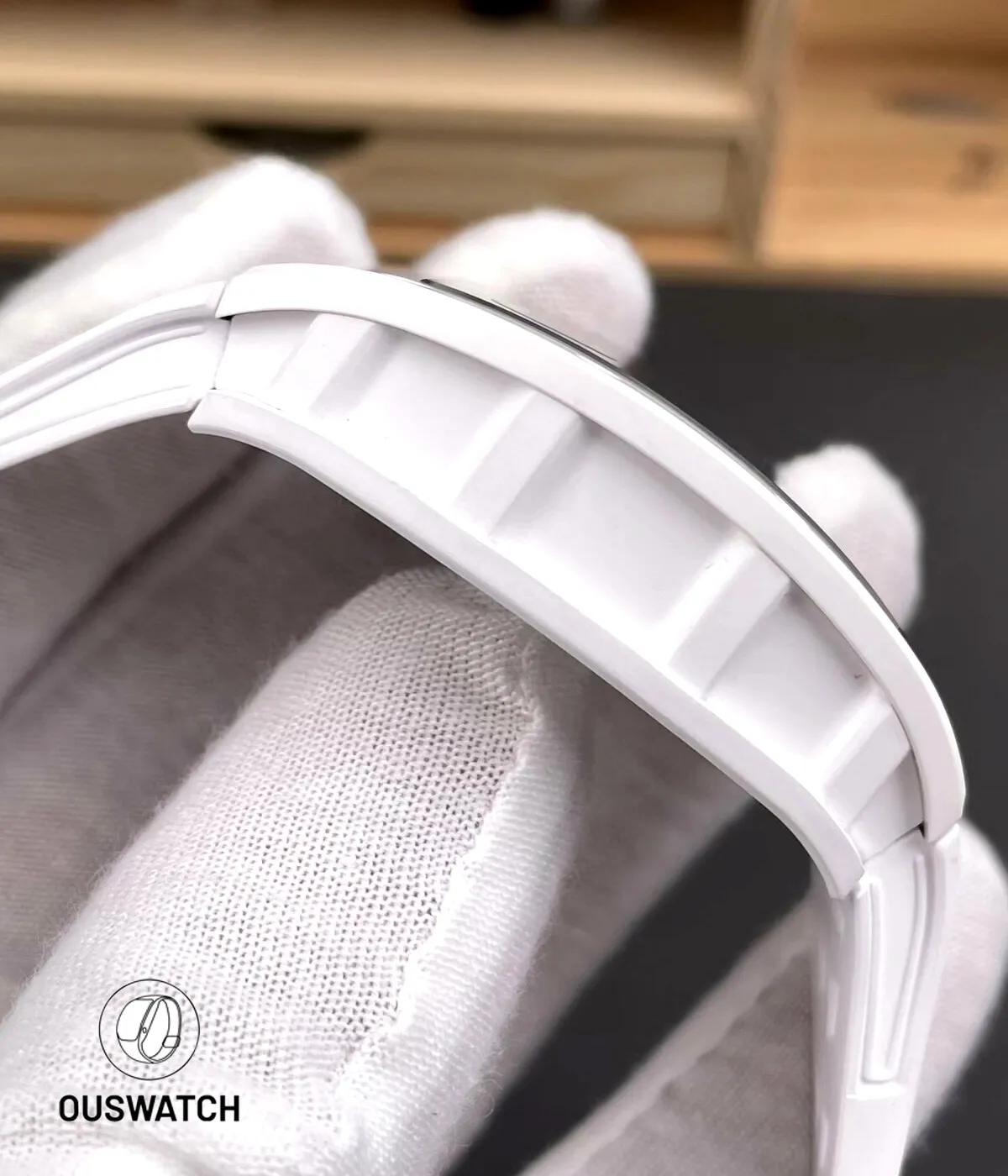 Side composition highlighting the white ceramic case profile of the RM055, showing matte texture and caseband contour.