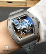 On-wrist lifestyle image of the RM 055 grey edition demonstrating scale, ergonomics and sporty presence.