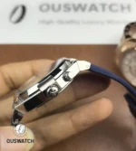 Close-up of the signed crown and case flank, showing knurling detail and the secure crown-tube interface.