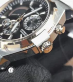 Close-up of the signed crown and surrounding case flank on the 47450 two-tone, showing knurling and polish transitions.