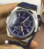 Architectural 75° angle highlighting the case curvature and the blue dial’s layered depth with light falloff.